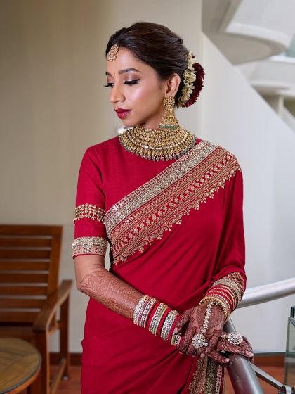 This image captures the elegance of a classic red bridal saree. You'll learn to create makeup that has a lasting, classic appeal.
