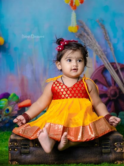 A little bit of heaven sent down to earth. The traditional pattu pavadai looks beautiful in our colorful setup.