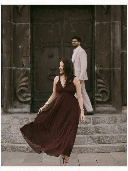 A beautiful, unposed moment in Georgia. The bride walks with a flowing dress down stone steps while the groom follows, his gaze entirely on her, capturing a natural and romantic interaction.