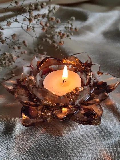 Another view of the resin lotus tea light holder. The shape of the petals and the preserved flowers inside create a stunning effect, making it a perfect decorative item for any occasion.