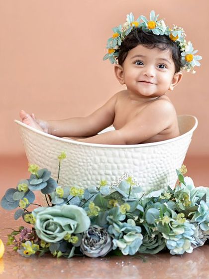 A beautiful floral tub bath setup. This little one looks like a flower princess in her bath.