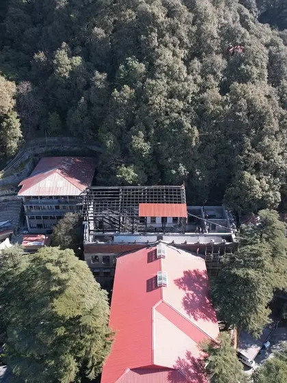 An aerial view of the Woodstock campus, showing our urban insert project mid-construction, carefully integrated into the dense forest and surrounding heritage buildings.