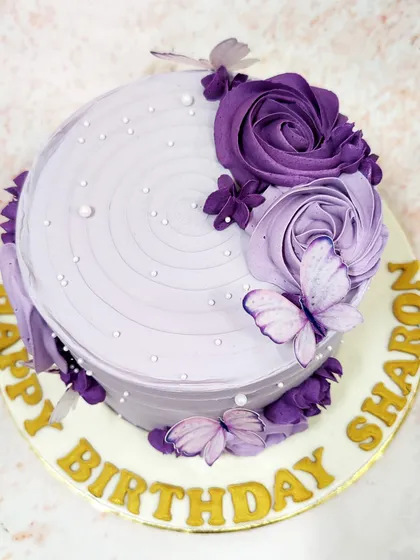 A top-down view of the butterfly pearl cake, highlighting the beautiful swirl on top and the placement of the butterflies.