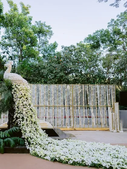 Floral artistry is at the heart of my work. This majestic peacock, with its cascading tail crafted entirely from pure white orchids and blossoms, served as a grand welcome, showcasing a unique blend of nature-inspired sculpture and luxurious wedding decor.