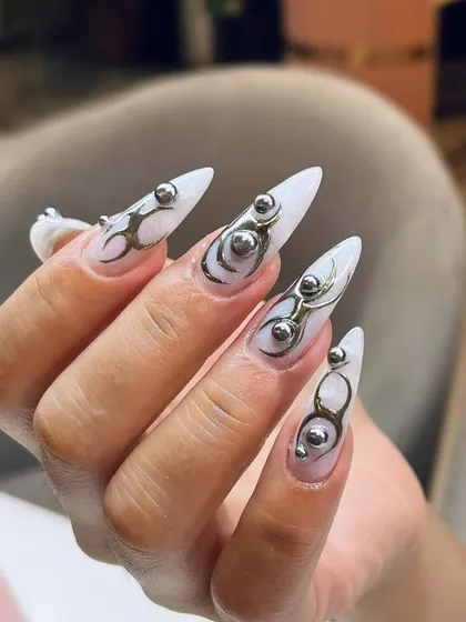 The sharp stiletto shape combined with fluid 3D chrome accents creates a look that is both edgy and artistic. We love creating these wearable sculptures.