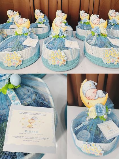 A collection of our 'sleeping baby on the moon' themed hampers in blue, perfect for welcoming a baby boy.
