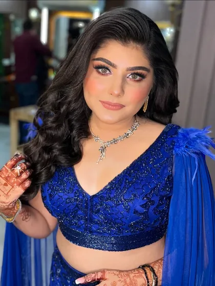 A close-up of this beautiful client. The eye makeup is a perfect smokey blend, and her skin is absolutely glowing.