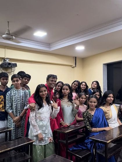 A happy group of students with Prof. Parab during the Satyanarayan Pooja. These celebrations create a festive and positive atmosphere within the classes.