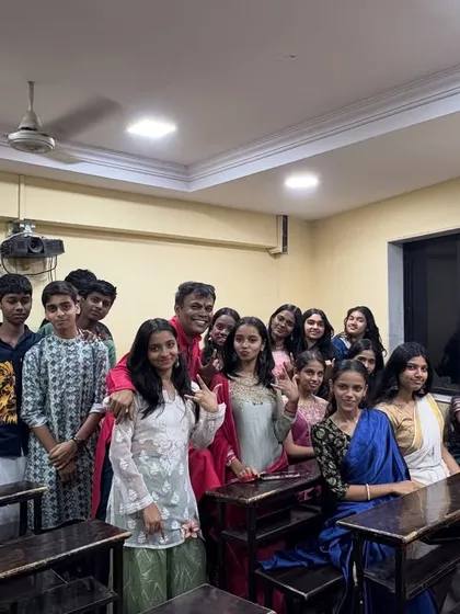 Prof. Parab with a group of students during the Satyanarayan Pooja. These informal interactions help build strong, supportive relationships between teachers and students.