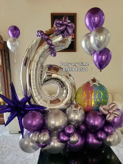 A 6th birthday balloon bouquet in purple and silver, with a star-shaped foil balloon.