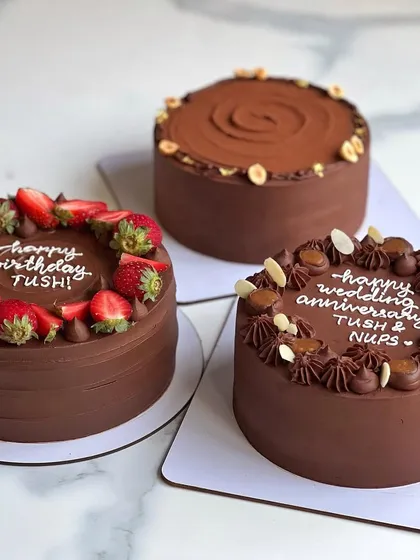 A trio of my most popular chocolate-based cakes. Can you recognize the flavors? From left to right: Chocolate Strawberry, Hazelnut Praline Feuilletine, and Chocolate Salted Caramel.