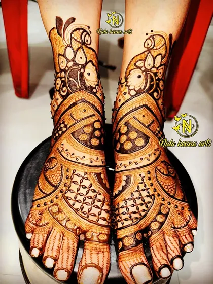 An intricate bridal leg design with peacock motifs and a variety of traditional Indian patterns, created by my skilled students.