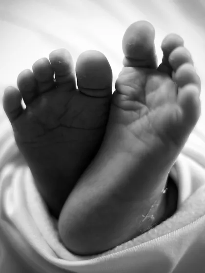 Those tiny feet! We always make sure to capture the little details that you'll want to remember forever. This black and white shot focuses on the perfection of a newborn's tiny toes.