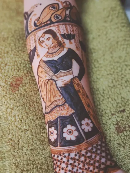 A finished bridal figure on an arm, showcasing a full-length portrait with detailed clothing and jewelry. This is the kind of advanced work my course prepares you for.