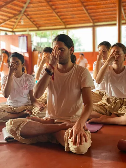 Students practice pranayama together in the shala. The synchronized breathing creates a powerful collective energy and deepens the meditative experience for everyone.