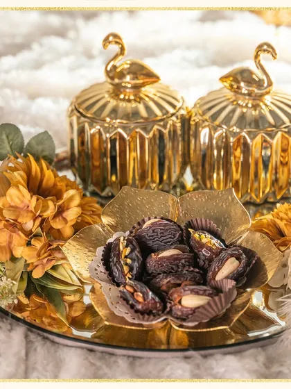 Embrace the spirit of Ramadan with this luxurious gourmet hamper. It features premium stuffed dates and elegant golden swan-topped jars, perfect for sharing sweetness and blessings.