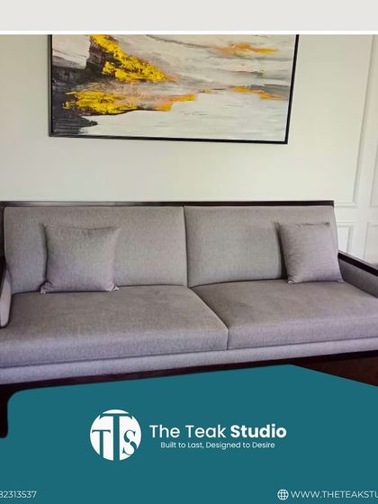 A simple yet elegant three-seater sofa with a dark wood frame and light grey upholstery. This versatile piece is perfect for creating a clean, minimalist look in any living room.