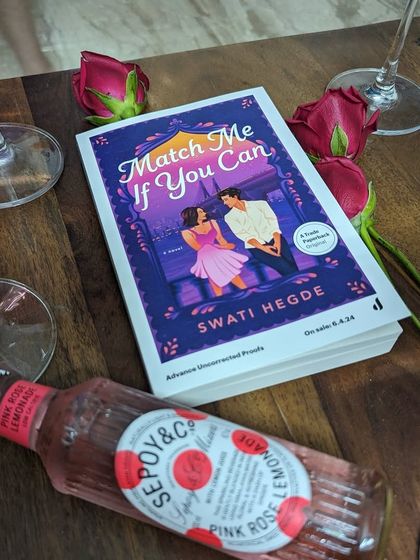 An advance copy of *Match Me If You Can* with some pink rosé lemonade, celebrating the journey of this book.