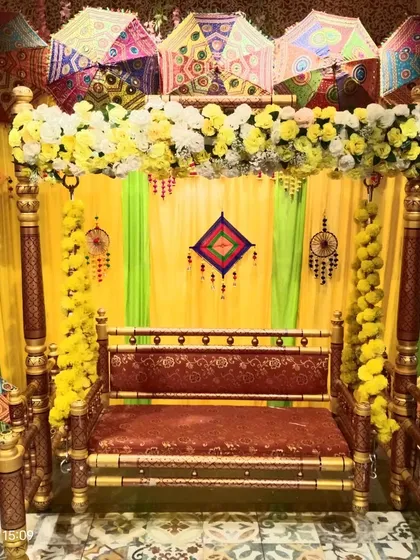This is our classic Haldi ceremony setup with a traditional wooden jhoola (swing). We use colorful Rajasthani umbrellas, marigold garlands, and bright yellow drapes to create a fun and authentic atmosphere.