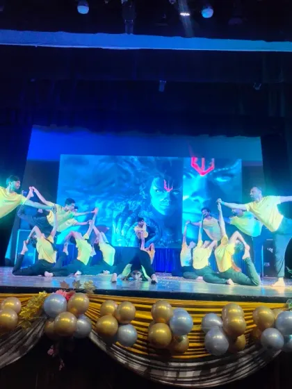 Our students holding a graceful, synchronized pose during their performance at the Shah Auditorium. Such events are a celebration of their progress and the vibrant community at Anubhuti Yog.