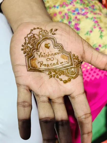 A simple yet meaningful design for a groom, featuring the couple's names, Vaishnavi and Prasad, inside an ornate frame. It's a sweet and personal touch.
