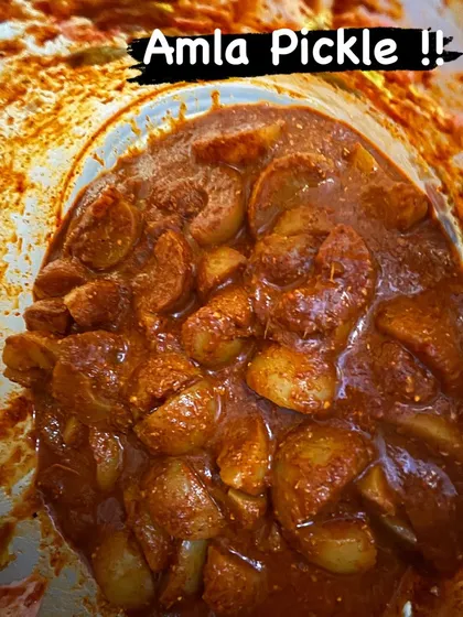A close-up of my tangy and spicy Amla pickle, also known as nellikai uppinakayi. Each piece of Indian gooseberry is coated in a rich, hand-ground masala, offering a perfect balance of flavours.