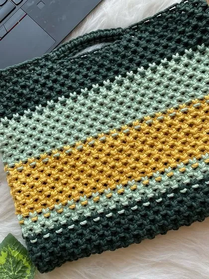 Yes, I make laptop bags too. This custom piece features bold stripes of forest green, mustard yellow, and mint, offering a unique and stylish way to protect your tech.