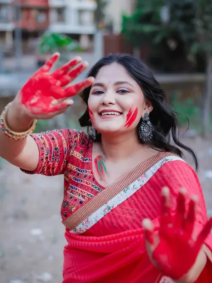 "Hands full of color, heart full of joy." This playful shot from our outdoor Holi series is all about interacting with the camera and sharing the fun.