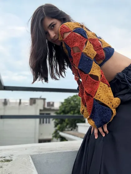 The open-shoulder detail and the way the squares connect is what makes this handmade crochet top so special. It's a design that is both airy and statement-making.