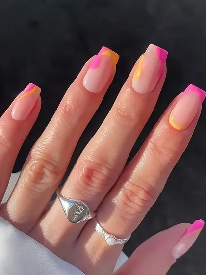 A fun, summery French manicure with a twist. This design features squared nails with a colorful combination of pink and yellow abstract tips for a bright and playful look.
