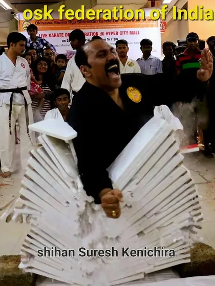 Power in karate comes from technique and spirit, not just brute force. This is a demonstration of Tameshiwari, or tile breaking, which requires immense focus and precise energy transfer. It is a skill honed over years of dedicated practice.