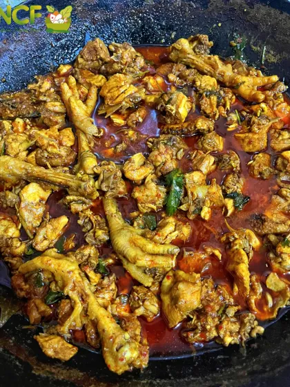 A large pot of country chicken curry, including chicken feet which are a delicacy in Manipuri cuisine. This is real, authentic home-style cooking.