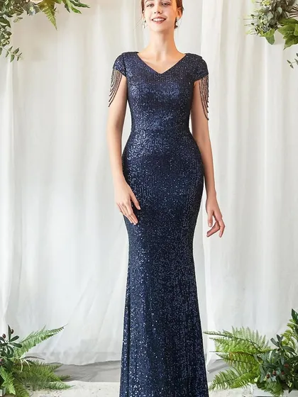Look effortlessly chic at your next reception or formal event in this navy blue sequin gown. The figure-hugging silhouette and delicate tassel details on the shoulders add a touch of modern glamour.