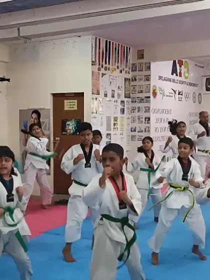 A dynamic shot of a green belt class practicing their forms.
