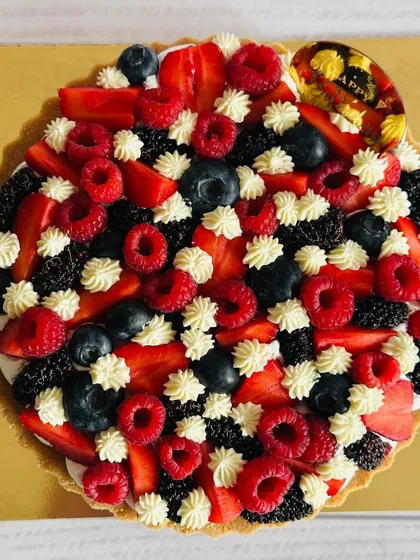 A berry-loaded masterpiece! This tart is covered with a medley of raspberries, mulberries, strawberries, and blueberries for a vibrant and delicious experience.