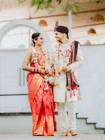 The couple taking a stroll, hand in hand. This photo captures a quiet, candid moment of connection between the newlyweds.