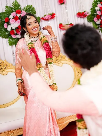Capturing the joy of an engagement party. Her makeup is soft and radiant, with a focus on glowing skin and bright eyes, perfect for a daytime ceremony. The traditional saree and jewelry complete this beautiful South Indian look.