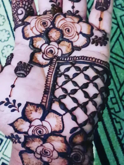 A close-up of a floral and geometric design on the palm, showing the shading techniques I use to give depth to the rose motifs.