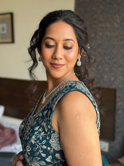The bride's serene expression is captured perfectly. The makeup is minimal yet elegant, enhancing her natural beauty.