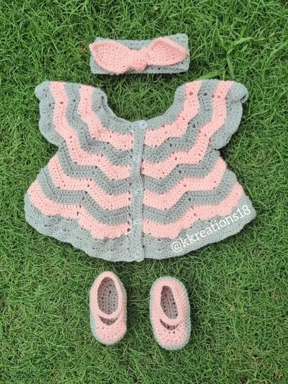 This is one of my favorite creations, a complete baby frock set in soft pink and grey. It includes a chevron-patterned dress, matching little booties, and a sweet bow headband. It’s a perfect, heartfelt gift for a baby shower or a newborn's first outfit.