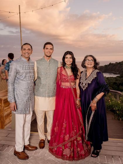 A beautiful family portrait. I also help style the family to ensure everyone's look is coordinated. Here, the couple is pictured with their parents, whose outfits complement the festive Sangeet theme.