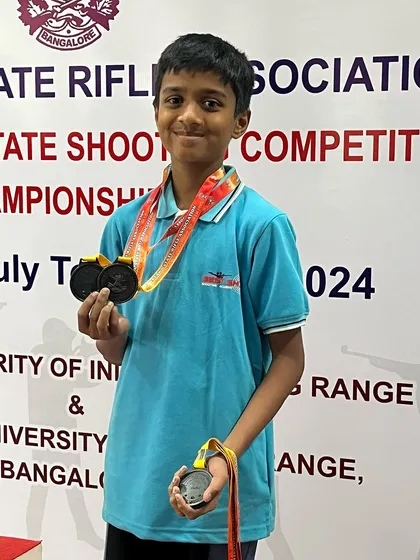 Young shooter Shyam proudly displays the two bronze medals he won in the Youth and Sub-Youth men's categories at the state level Air Pistol competition.