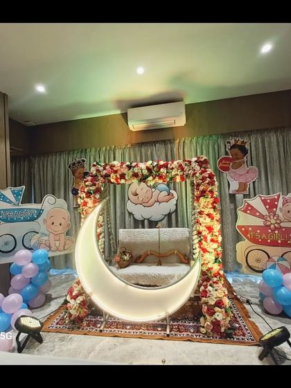 The same home baby shower setup from a different angle, showing the beautiful arrangement on a patterned rug.