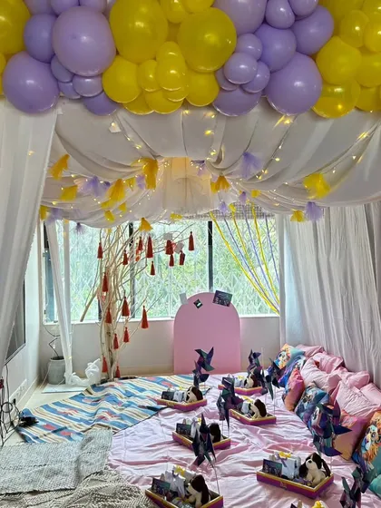 We love creating cozy and fun sleepover parties. This setup included a beautiful tent with fairy lights, custom cushions, a snack bar, and personalized gift hampers for each guest.