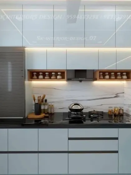 A minimalist kitchen with handle-less white cabinets and open wooden niches for spices. The design is clean and functional, with a built-in rolling shutter for appliances.