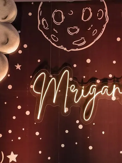 A custom neon sign with the birthday girl's name, set against a starry galaxy backdrop.