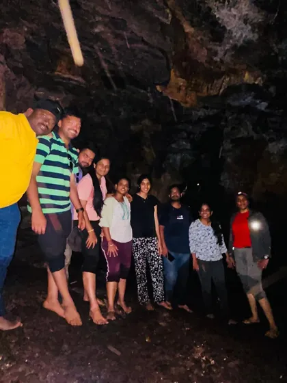 A group photo inside a dark cave, illuminated by our lights. The sense of discovery is amazing.
