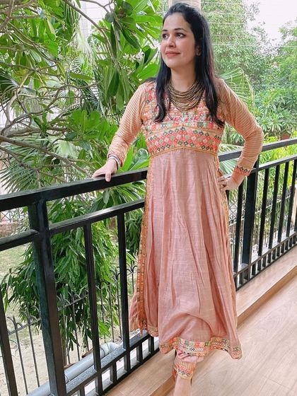 This peach embroidered Anarkali suit is another favorite. The delicate embroidery and soft color make it a very elegant choice for daytime festive events or pujas.