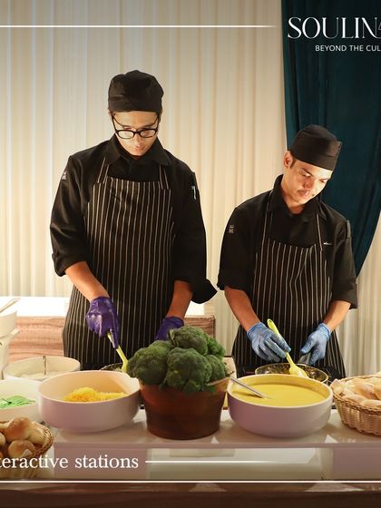 Our chefs at an interactive station, preparing fresh dishes for a corporate event. Live stations add an engaging element to any gathering.