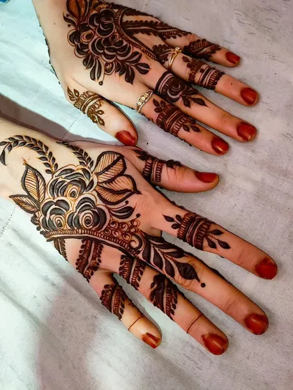 A minimal floral design that focuses on the back of the hand, using negative space to create a light, airy feel.